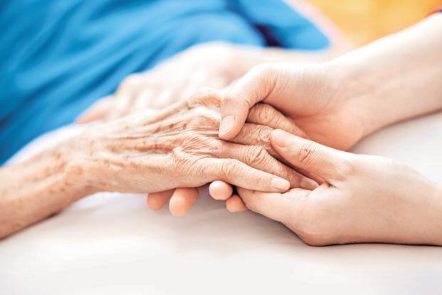young hands holding elderly hand