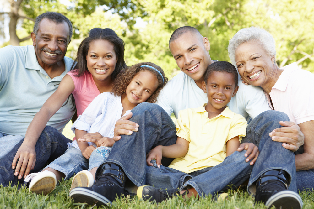 Multi Generation Family Relaxing In Park