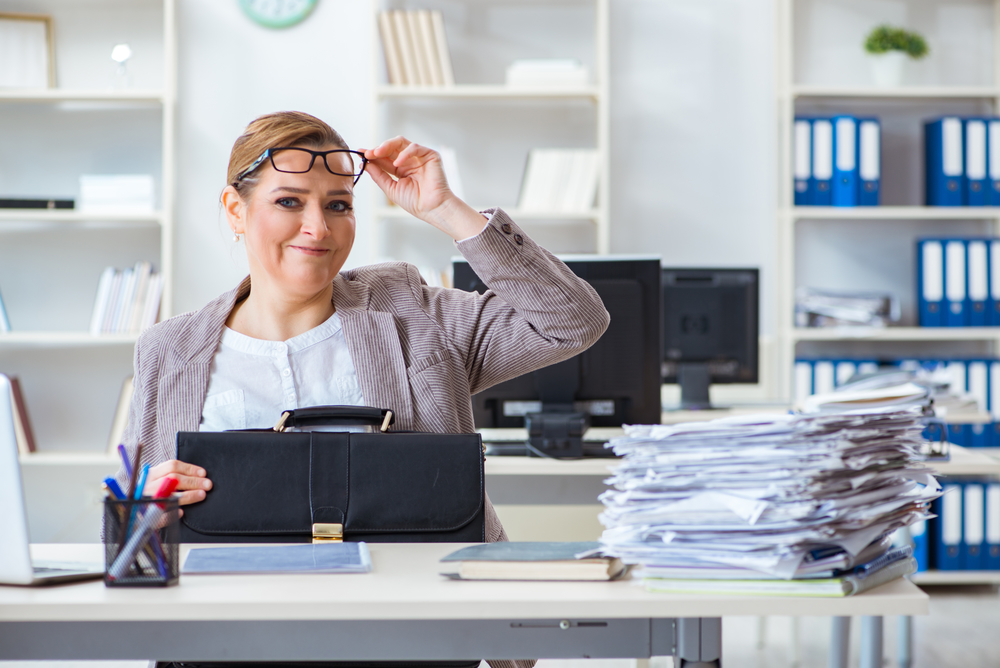 Businesswoman very busy with ongoing paperwork