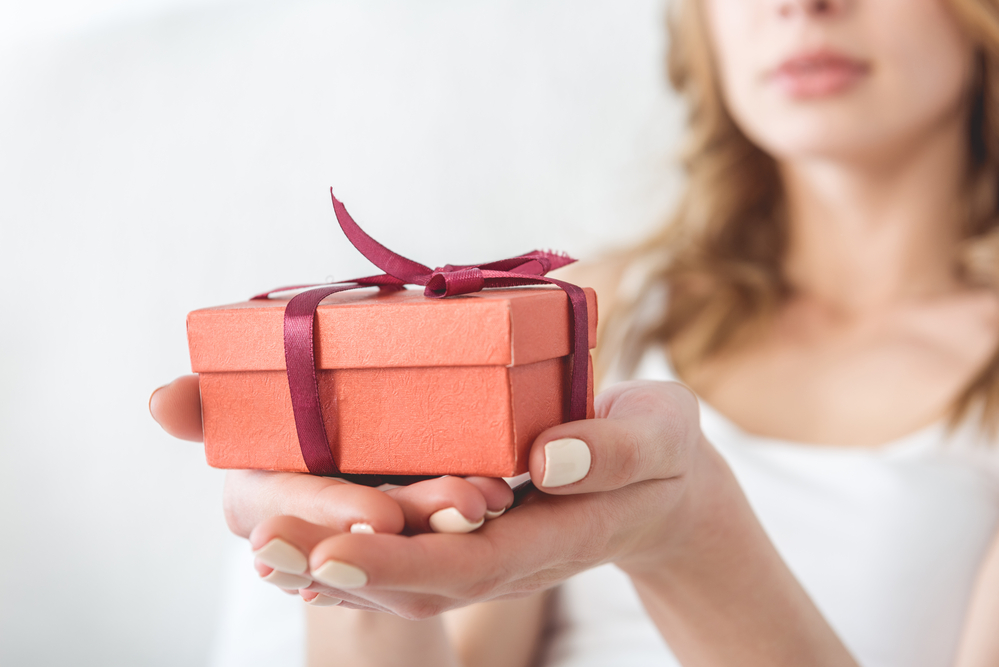 Close up of small gift being held by a woman.