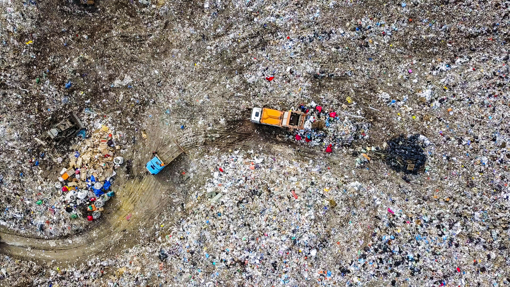 Garbage trucks unload garbage to a landfill in the vicinity of the city of Yekaterinburg, Russia, From Drone, HEAD OVER SHOT