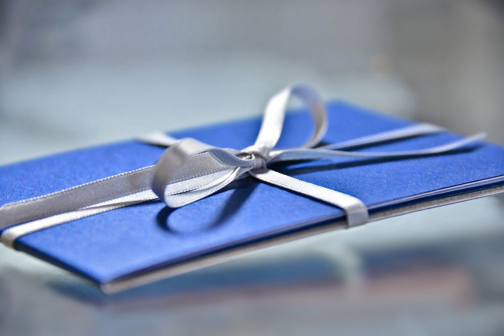 Side view of a gift card wrapped in Chanukah colors.